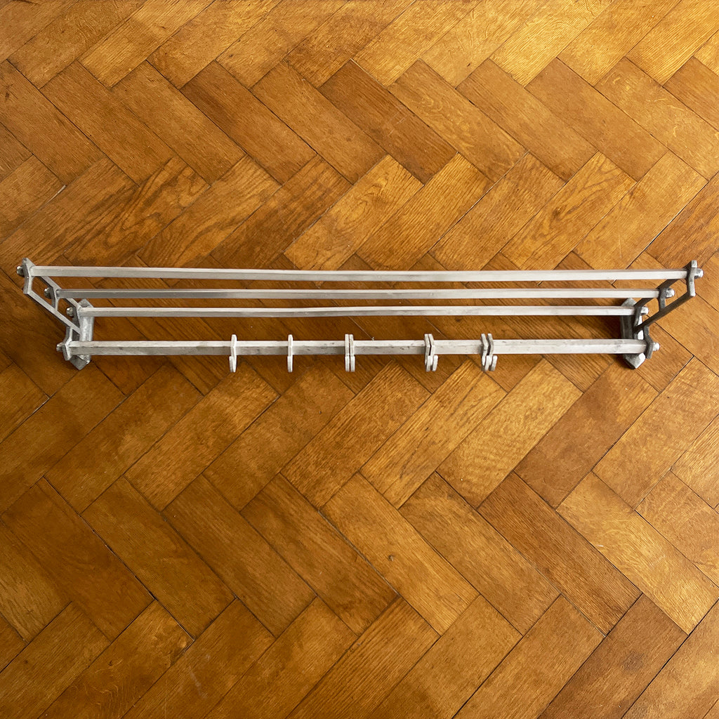 An Aluminium Art Deco Train Coat Rack, having three slats to the top section where you can place your hats and a bottom ball that has eight sliding coat hooks. The ends have a simple Art Deco styling to them - SHOP NOW - www.intovintage.co.uk