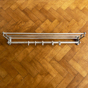 An Aluminium Art Deco Train Coat Rack, having three slats to the top section where you can place your hats and a bottom ball that has eight sliding coat hooks. The ends have a simple Art Deco styling to them - SHOP NOW - www.intovintage.co.uk