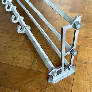 An Aluminium Art Deco Train Coat Rack, having three slats to the top section where you can place your hats and a bottom ball that has eight sliding coat hooks. The ends have a simple Art Deco styling to them - SHOP NOW - www.intovintage.co.uk