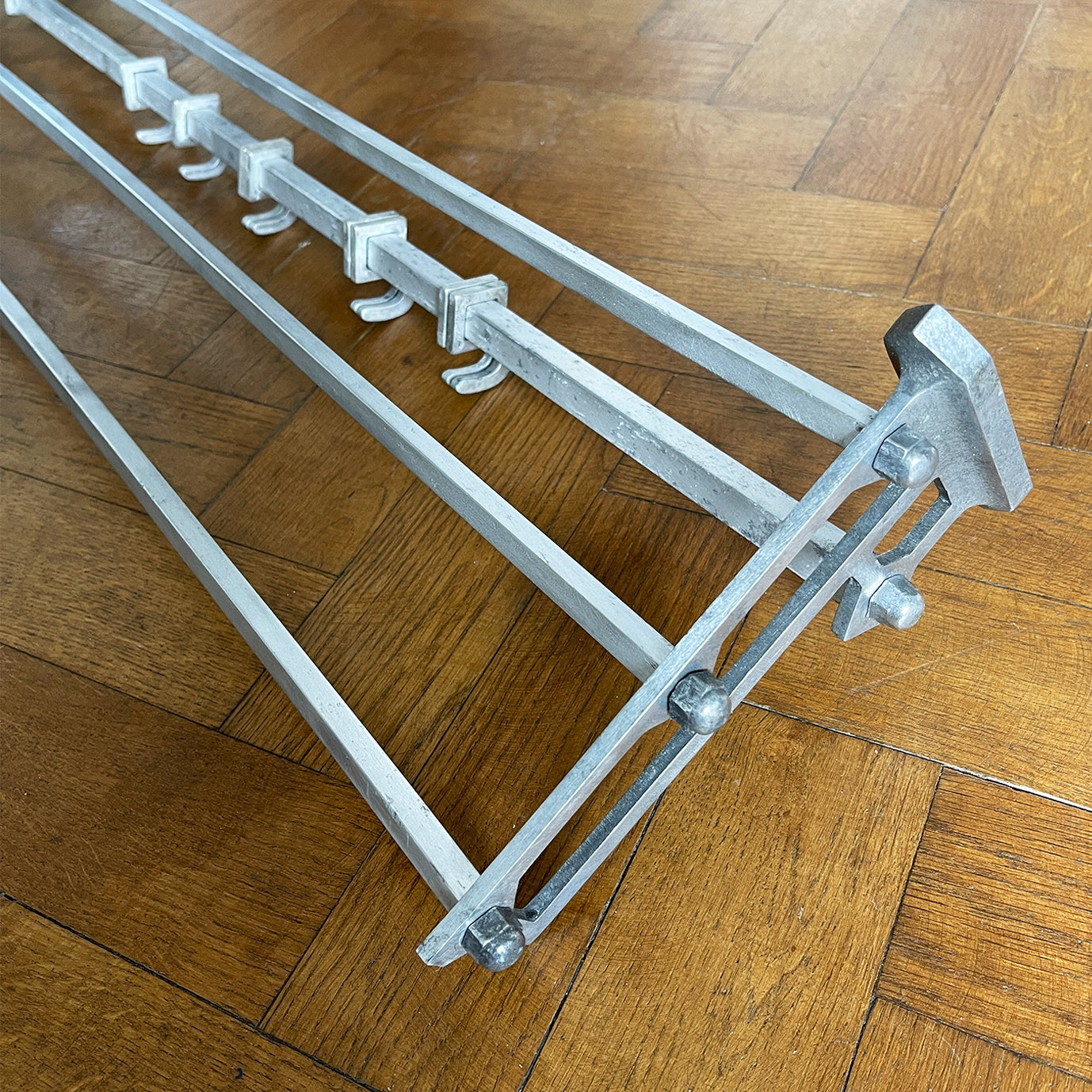 An Aluminium Art Deco Train Coat Rack, having three slats to the top section where you can place your hats and a bottom ball that has eight sliding coat hooks. The ends have a simple Art Deco styling to them - SHOP NOW - www.intovintage.co.uk
