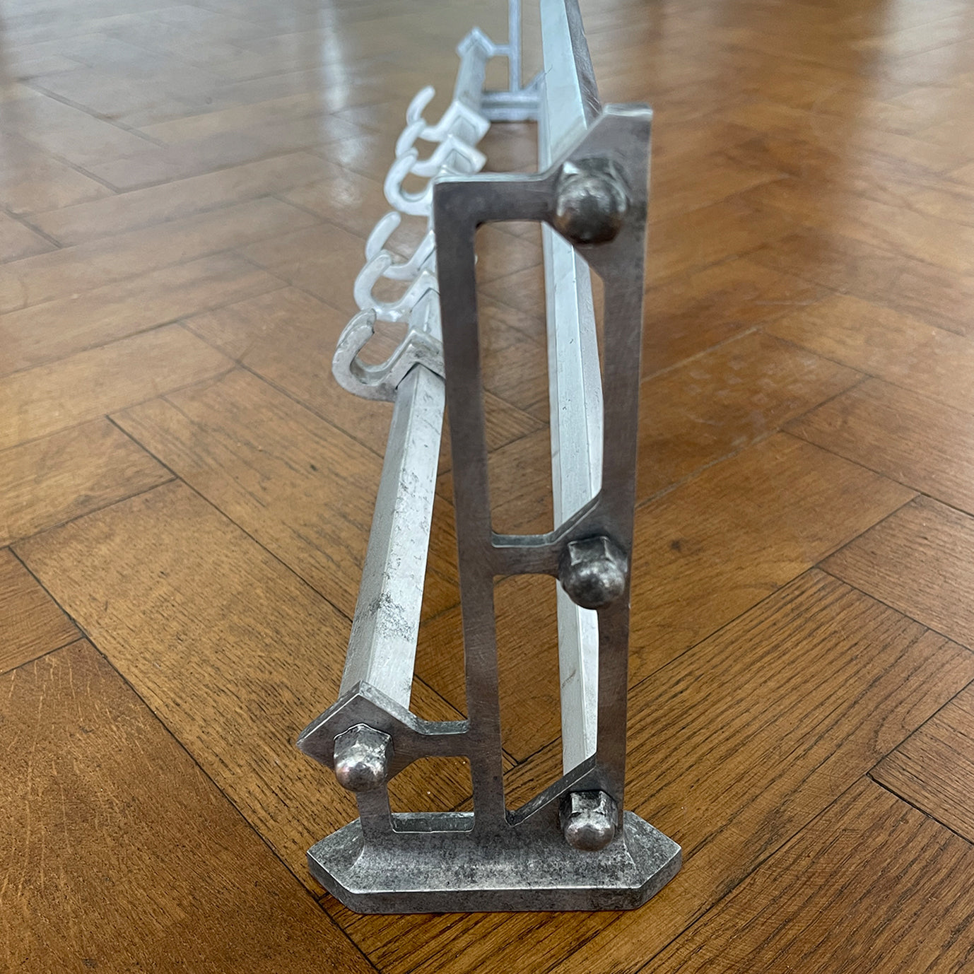 An Aluminium Art Deco Train Coat Rack, having three slats to the top section where you can place your hats and a bottom ball that has eight sliding coat hooks. The ends have a simple Art Deco styling to them - SHOP NOW - www.intovintage.co.uk