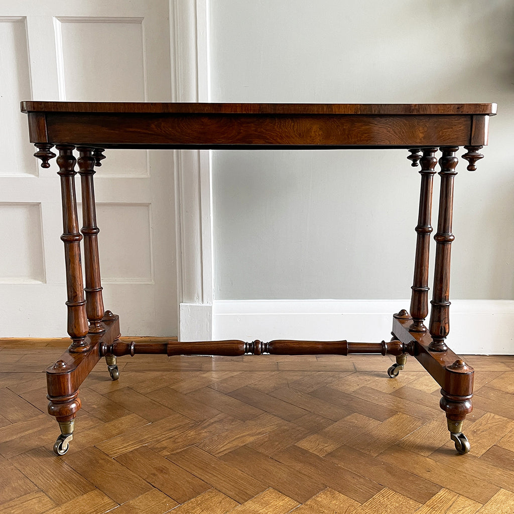 A mid Victorian rosewood stretcher base table with well figured rectangular top that sits upon turned legs and stretcher, raised on original brass castors. English. Superb condition. - SHOP NOW - www.intovintage.co.uk