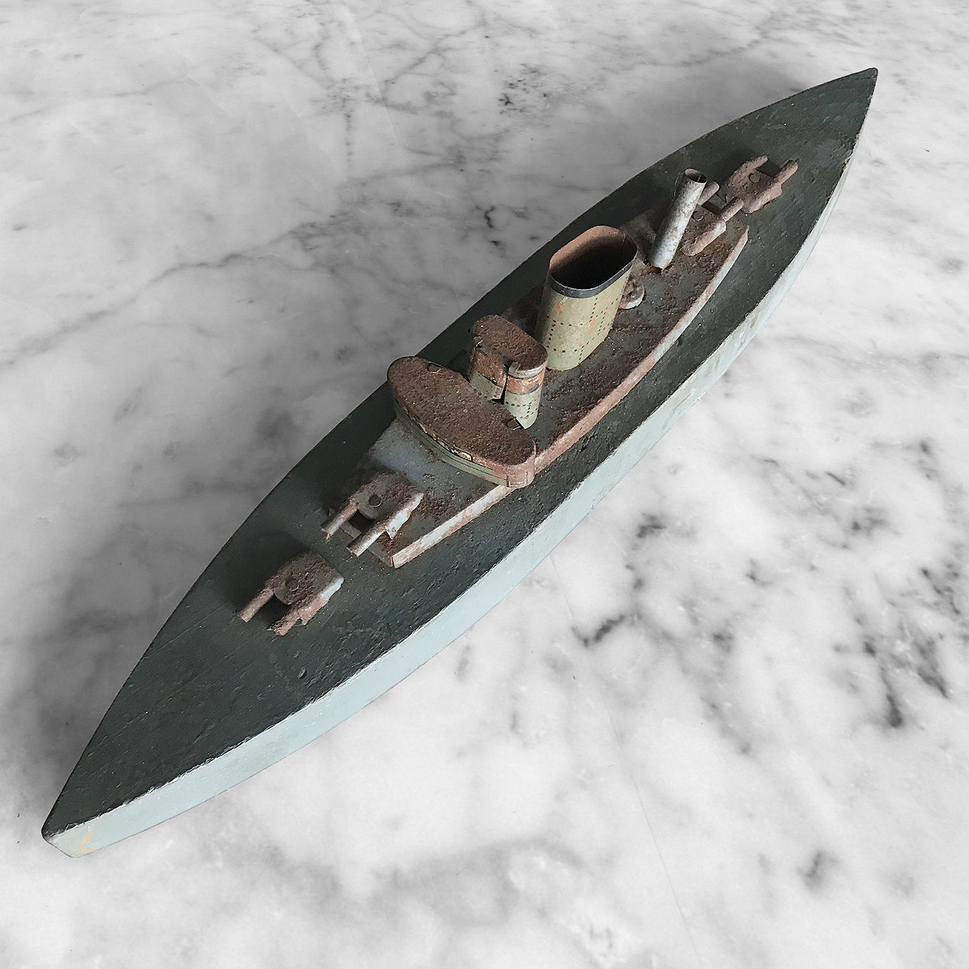 In rust we trust... Stylish old wood and lithographed tin plate battle ship with a great patina. Four gun turrets, three funnels and bridge with tiny sailors at the helm - SHOP NOW - www.intovintage.co.uk