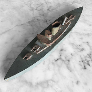 In rust we trust... Stylish old wood and lithographed tin plate battle ship with a great patina. Four gun turrets, three funnels and bridge with tiny sailors at the helm - SHOP NOW - www.intovintage.co.uk