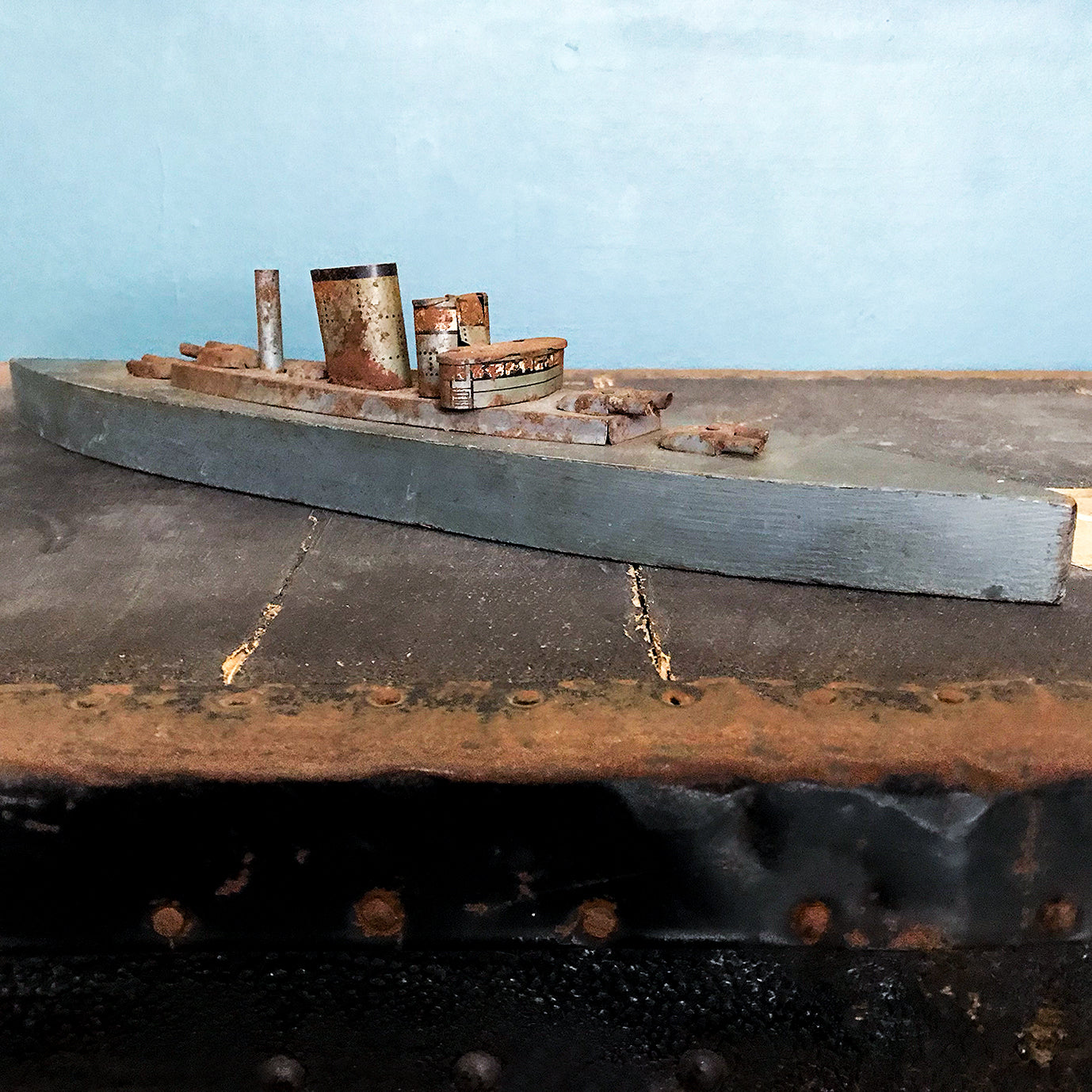In rust we trust... Stylish old wood and lithographed tin plate battle ship with a great patina. Four gun turrets, three funnels and bridge with tiny sailors at the helm - SHOP NOW - www.intovintage.co.uk