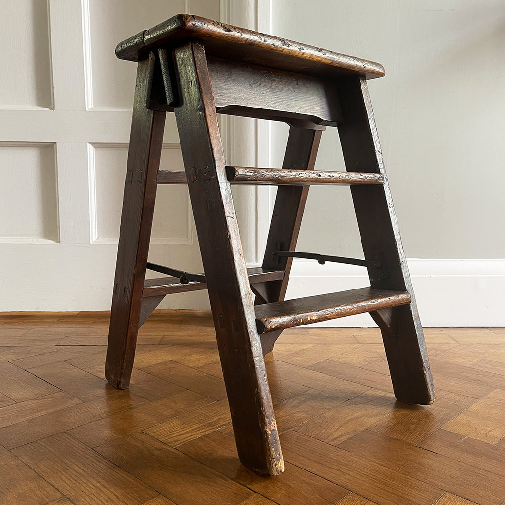 A Vintage Set of Dark Pine Folding Steps. With iron hinged stretchers and great colour and wear. They fold on a central hinge so nice and easy to store - SHOP NOW - www.intovintage.co.uk