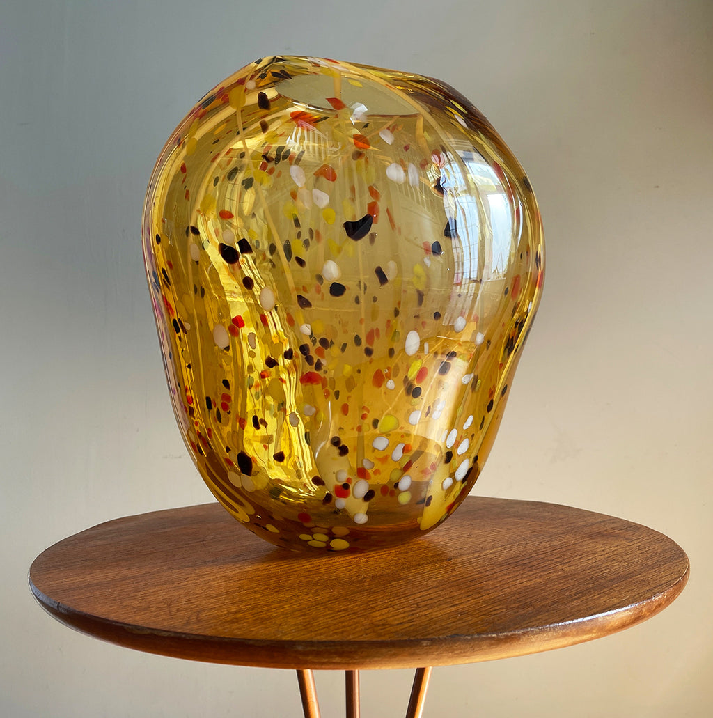 A stunning large organic hand blown glass vase. Having flecks of chocolate brown, deep orange, yellow and white within the main body of the glass giving it an almost boiled sweet look that catches the light beautifully. A nice flat bottom keeps it nice and stable.  - SHOP NOW - www.intovintage.co.uk