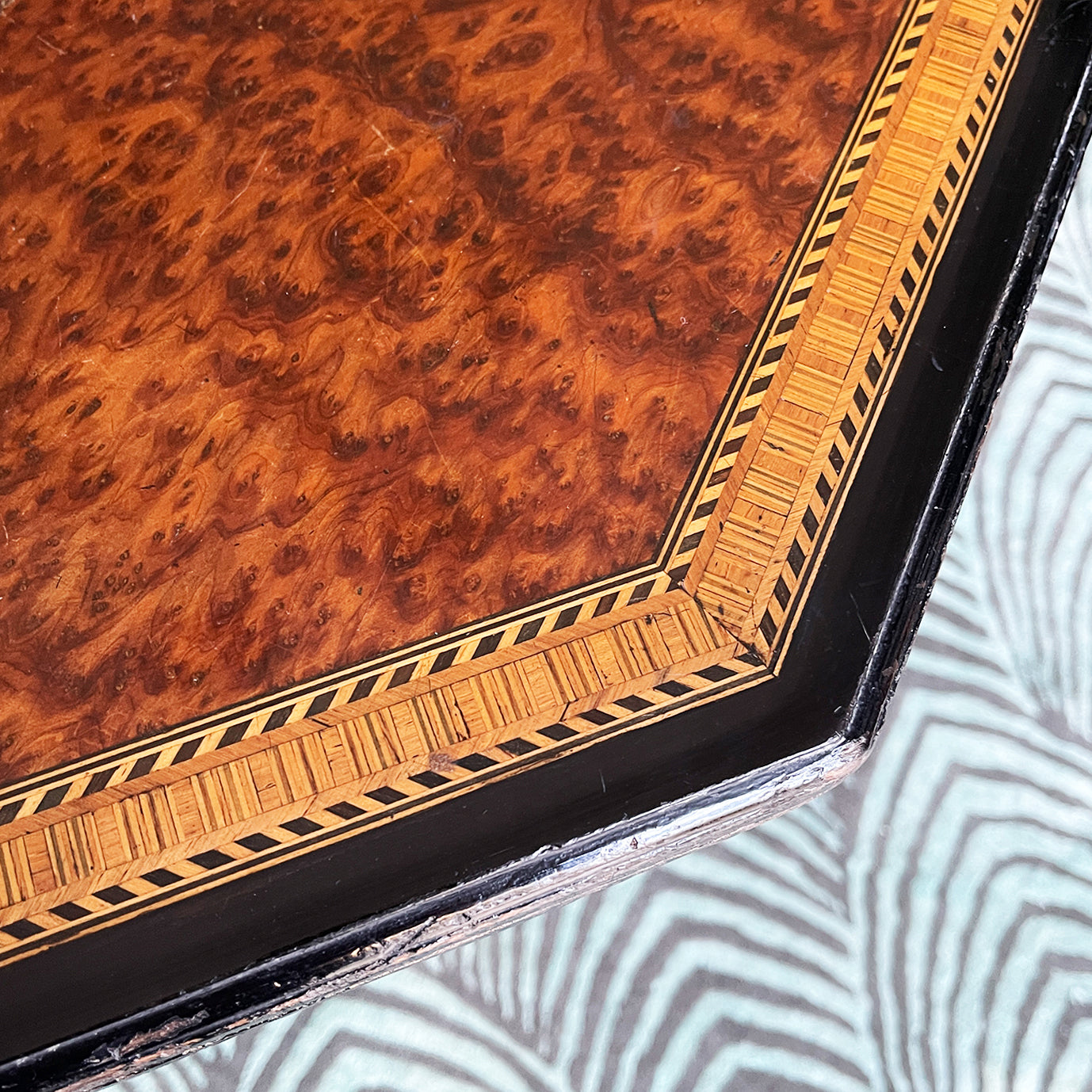 A Victorian marquetry & ebonised octagonal centre table in the Aesthetic manner by Alexander Mackenzie & Co, Glasgow.The top sees a rich burr wood veneer edged with fine blond wood marquetry, whilst underneath sees four turned ebonised legs with gold painted detailing and crossed bobbin stretchers - SHOP NOW - www.intovintage.co.uk