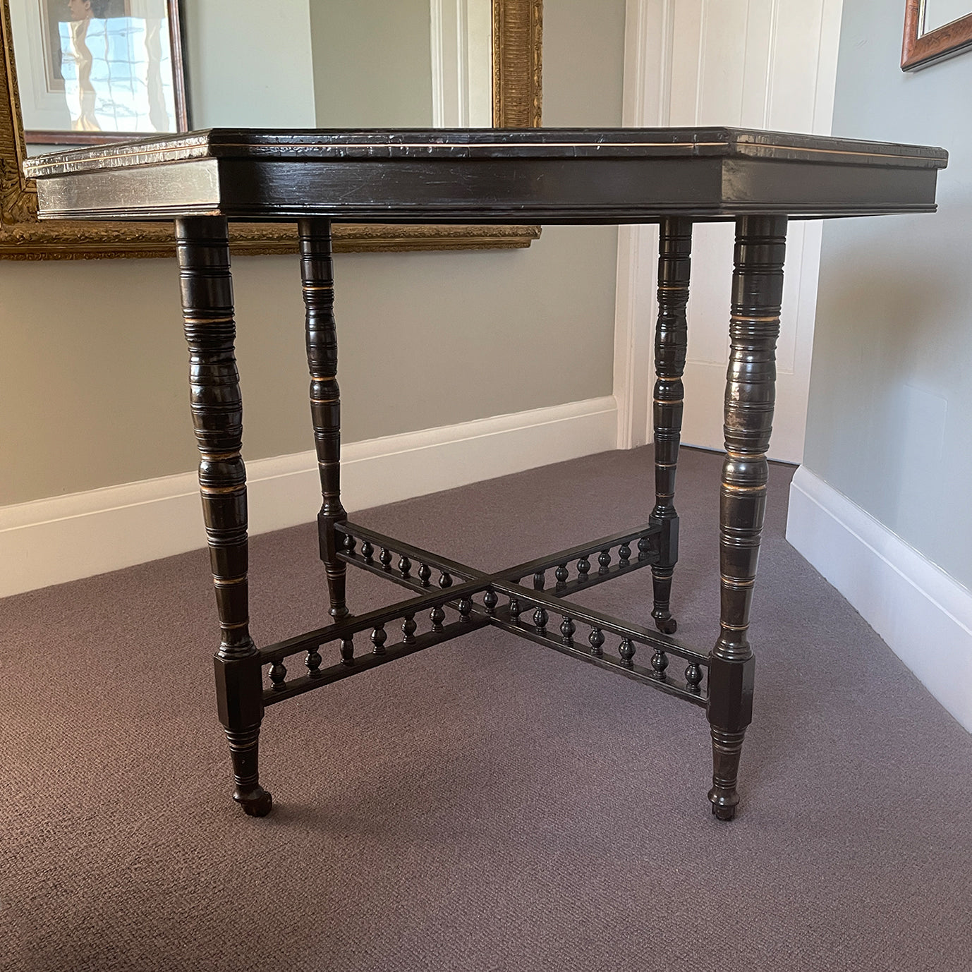 A Victorian marquetry & ebonised octagonal centre table in the Aesthetic manner by Alexander Mackenzie & Co, Glasgow.The top sees a rich burr wood veneer edged with fine blond wood marquetry, whilst underneath sees four turned ebonised legs with gold painted detailing and crossed bobbin stretchers - SHOP NOW - www.intovintage.co.uk