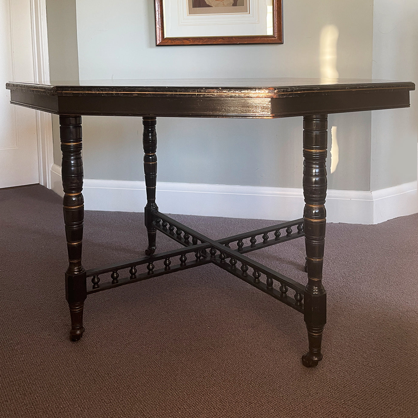 A Victorian marquetry & ebonised octagonal centre table in the Aesthetic manner by Alexander Mackenzie & Co, Glasgow.The top sees a rich burr wood veneer edged with fine blond wood marquetry, whilst underneath sees four turned ebonised legs with gold painted detailing and crossed bobbin stretchers - SHOP NOW - www.intovintage.co.uk