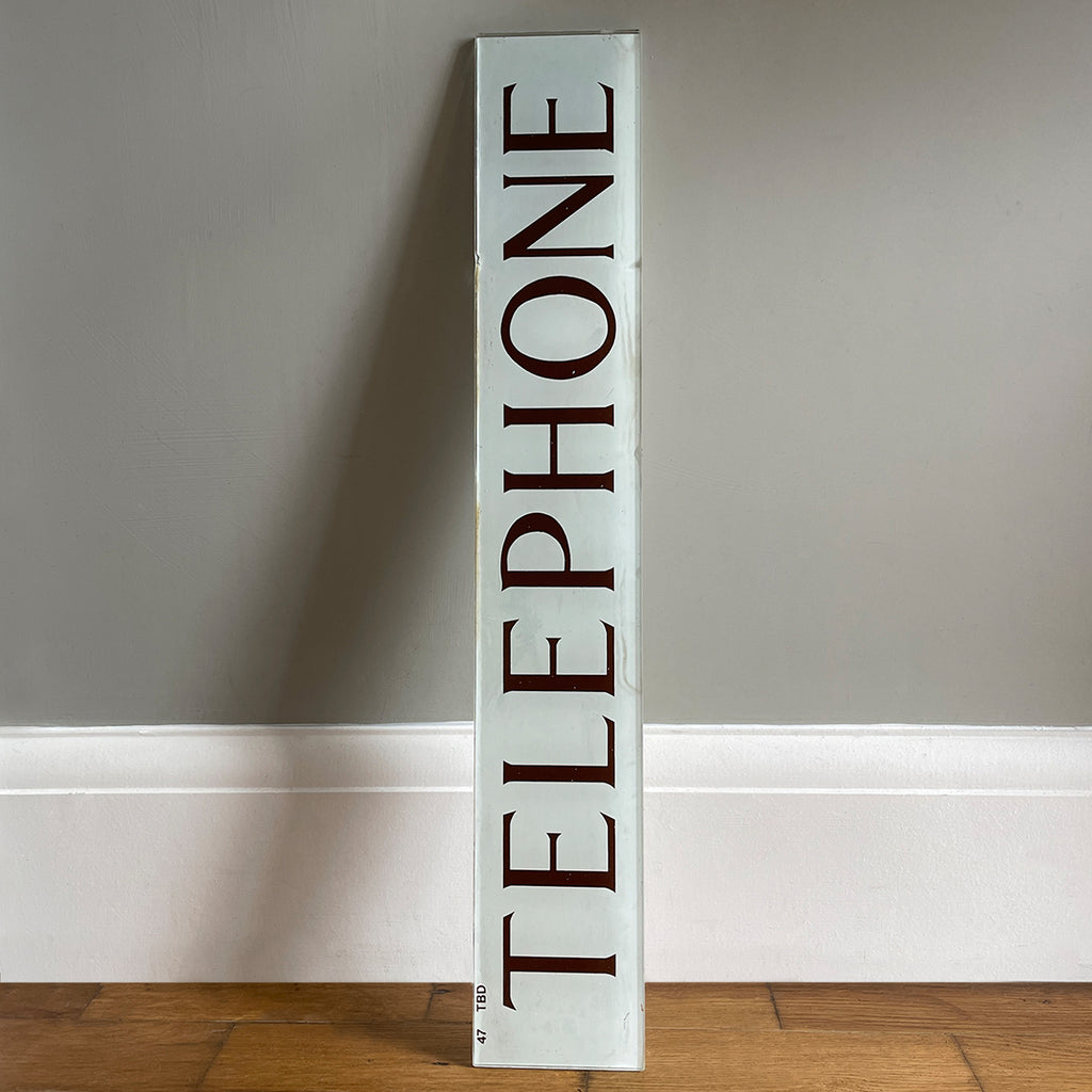 A Vintage Glass Telephone Sign from a British Red Phone Box. Transfer printed to the back of glass plate. The type is in a deep burgundy colour on to a white background - SHOP NOW - www.intovintage.co.uk 