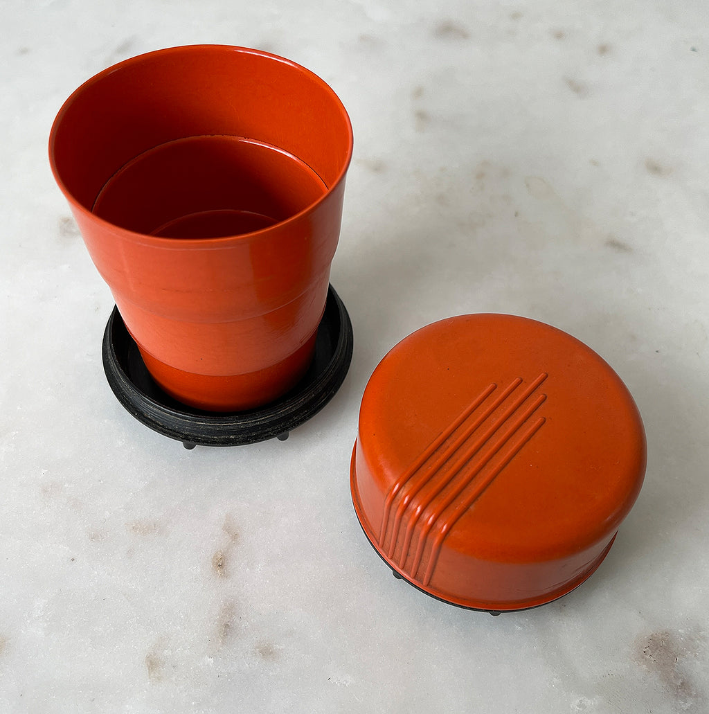 A pair of Art Deco Bakelite Telescopic Cups in a popping orange colour with black base. Unscrew the lid and pull up the rim inside to create a water tight cup! The perfect size to keep in your pocket for a little tipple if you are out and about - SHOP NOW - www.intovintage.co.uk