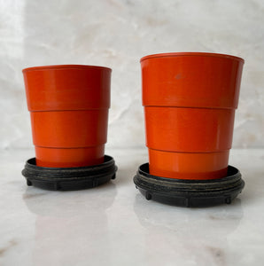 A pair of Art Deco Bakelite Telescopic Cups in a popping orange colour with black base. Unscrew the lid and pull up the rim inside to create a water tight cup! The perfect size to keep in your pocket for a little tipple if you are out and about - SHOP NOW - www.intovintage.co.uk