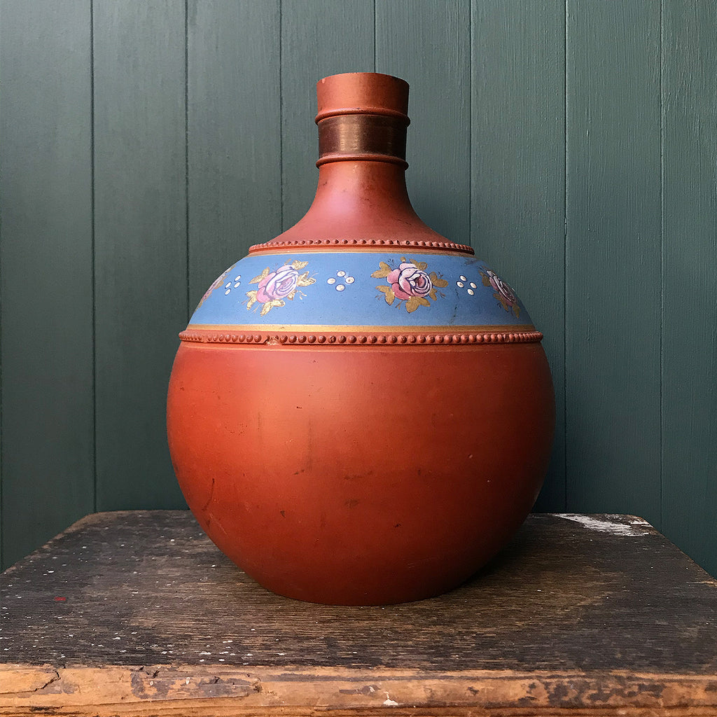 A gorgeous Victorian hand painted terracotta Vase. With bulbous form with pinkish roses with gold leaves hand painted on to a petrol blue background and finished with a raised dotted border. A beautiful decorative piece for the home - SHOP NOW - www.intovintage.co.uk