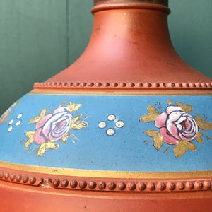 A gorgeous Victorian hand painted terracotta Vase. With bulbous form with pinkish roses with gold leaves hand painted on to a petrol blue background and finished with a raised dotted border. A beautiful decorative piece for the home - SHOP NOW - www.intovintage.co.uk