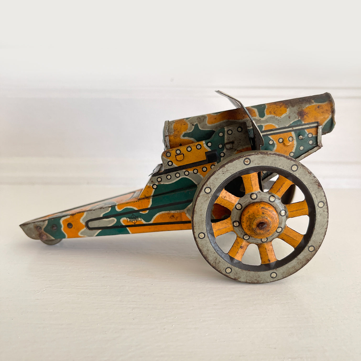 A Pre-War 1930s SHOWA tin-plate clockwork Cannon. It has a clockwork movement, that when wound moves the cannon forward, shooting bright sparks out of the gun barrel then backwards again as if the gun has recoiled! - SHOP NOW - www.intovintage.co.uk