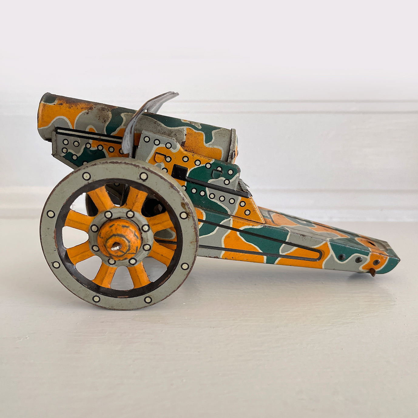 A Pre-War 1930s SHOWA tin-plate clockwork Cannon. It has a clockwork movement, that when wound moves the cannon forward, shooting bright sparks out of the gun barrel then backwards again as if the gun has recoiled! - SHOP NOW - www.intovintage.co.uk