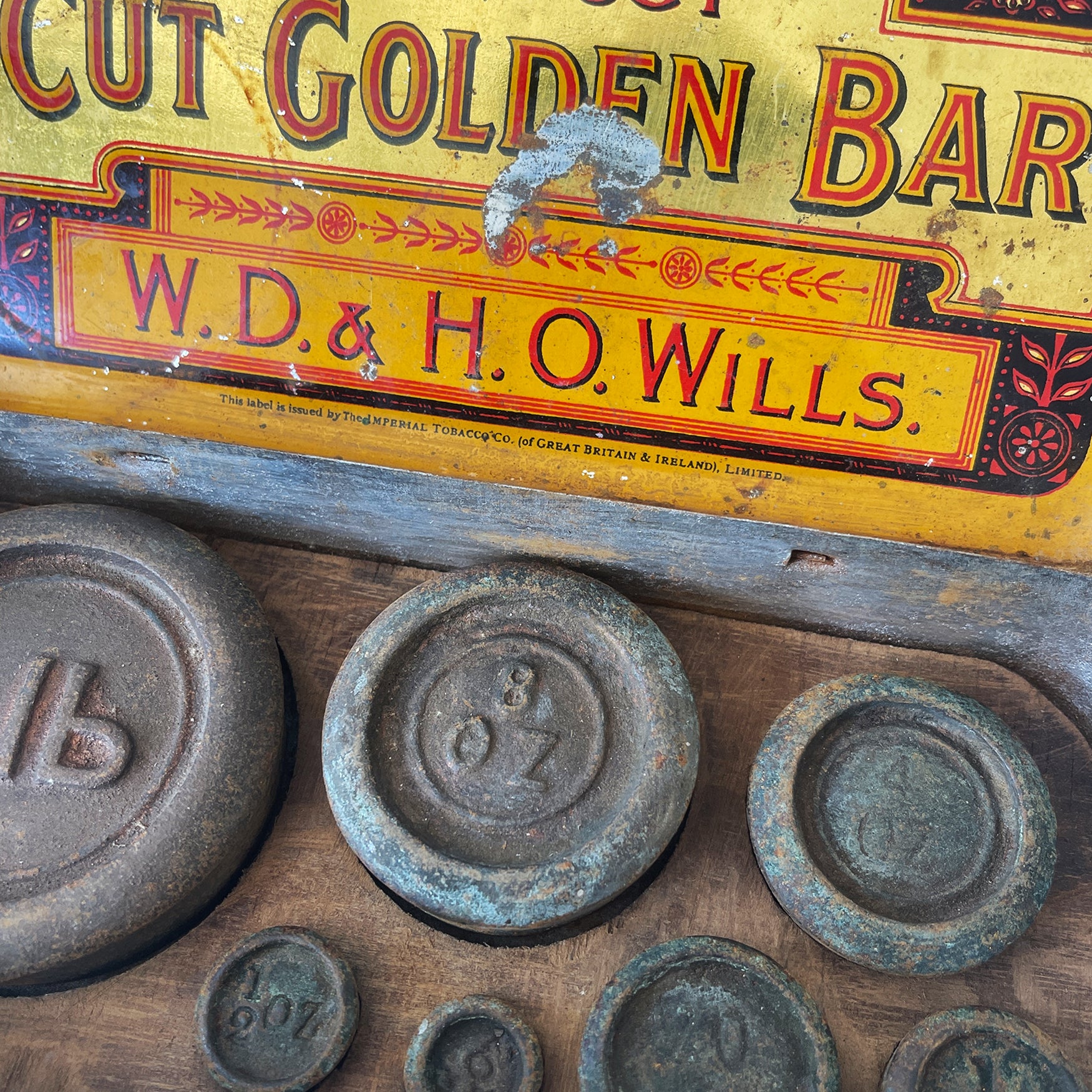 A Vintage Cut Golden Bar Wills Tobacco Tin from W.D & H.O Wills. Great colourful Typography to the inside lid, with an integral set of weights. - SHOP NOW - www.intovintage.co.uk