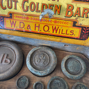 A Vintage Cut Golden Bar Wills Tobacco Tin from W.D & H.O Wills. Great colourful Typography to the inside lid, with an integral set of weights. - SHOP NOW - www.intovintage.co.uk