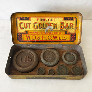 A Vintage Cut Golden Bar Wills Tobacco Tin from W.D & H.O Wills. Great colourful Typography to the inside lid, with an integral set of weights. - SHOP NOW - www.intovintage.co.uk