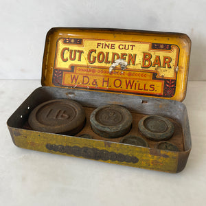 A Vintage Cut Golden Bar Wills Tobacco Tin from W.D & H.O Wills. Great colourful Typography to the inside lid, with an integral set of weights. - SHOP NOW - www.intovintage.co.uk