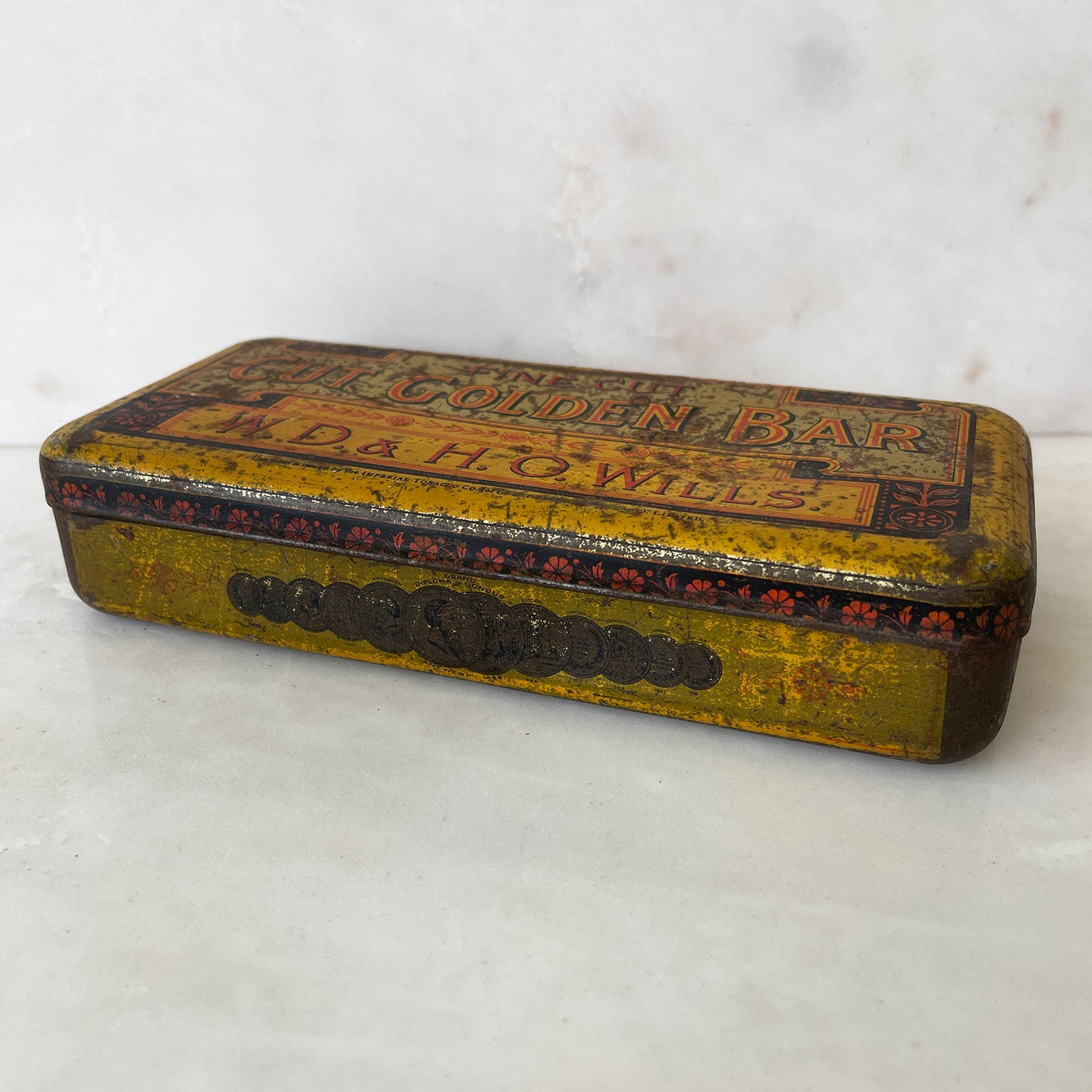 A Vintage Cut Golden Bar Wills Tobacco Tin from W.D & H.O Wills. Great colourful Typography to the inside lid, with an integral set of weights. - SHOP NOW - www.intovintage.co.uk