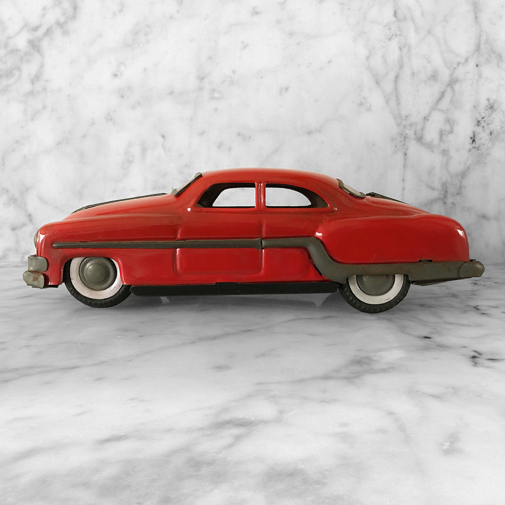 Cool 1950s tin-plate Pontiac toy car by "Minister Delux". It has a friction movement, good body work and plastic windows/screens to front and back - SHOP NOW - www.intovintage.co.uk