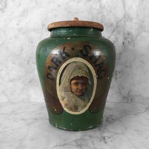 Antique Dark Shag Tobacco Jar. Finished in a wonderfully distressed deep bottle green with the words 'DARK SHAG' on a gold background above the image of a young lady in period dress - SHOP NOW - www.intovintage.co.uk
