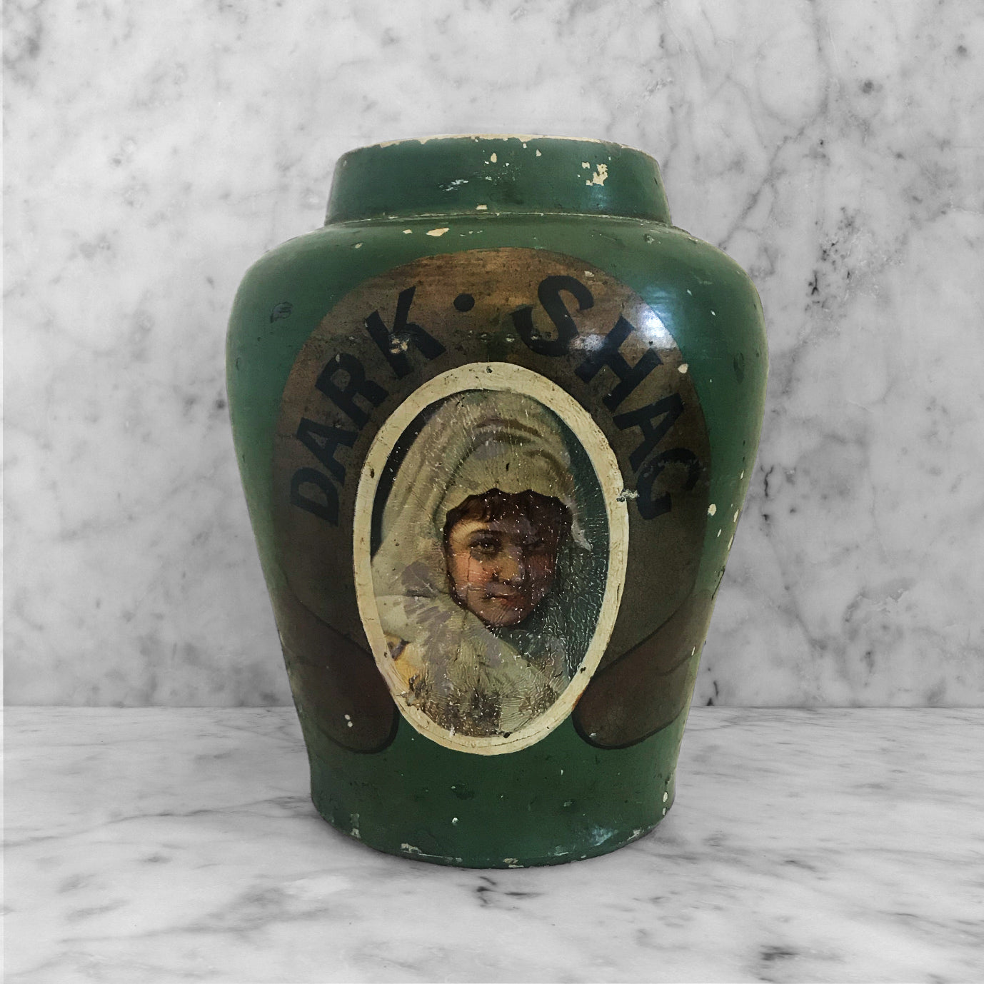 Antique Dark Shag Tobacco Jar. Finished in a wonderfully distressed deep bottle green with the words 'DARK SHAG' on a gold background above the image of a young lady in period dress - SHOP NOW - www.intovintage.co.uk