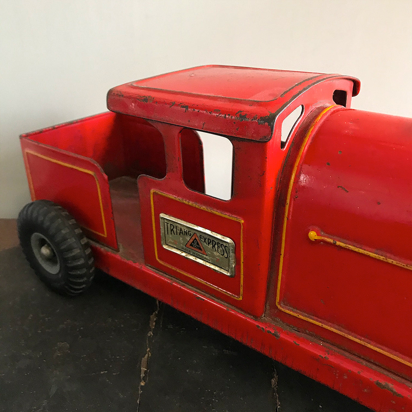 Vintage Tri-ang Express Toy Train. Finished in a glorious red colour with yellow painted details. It has two original Tri-ang Express decals on its sides - SHOP NOW - www.intovintage.co.uk