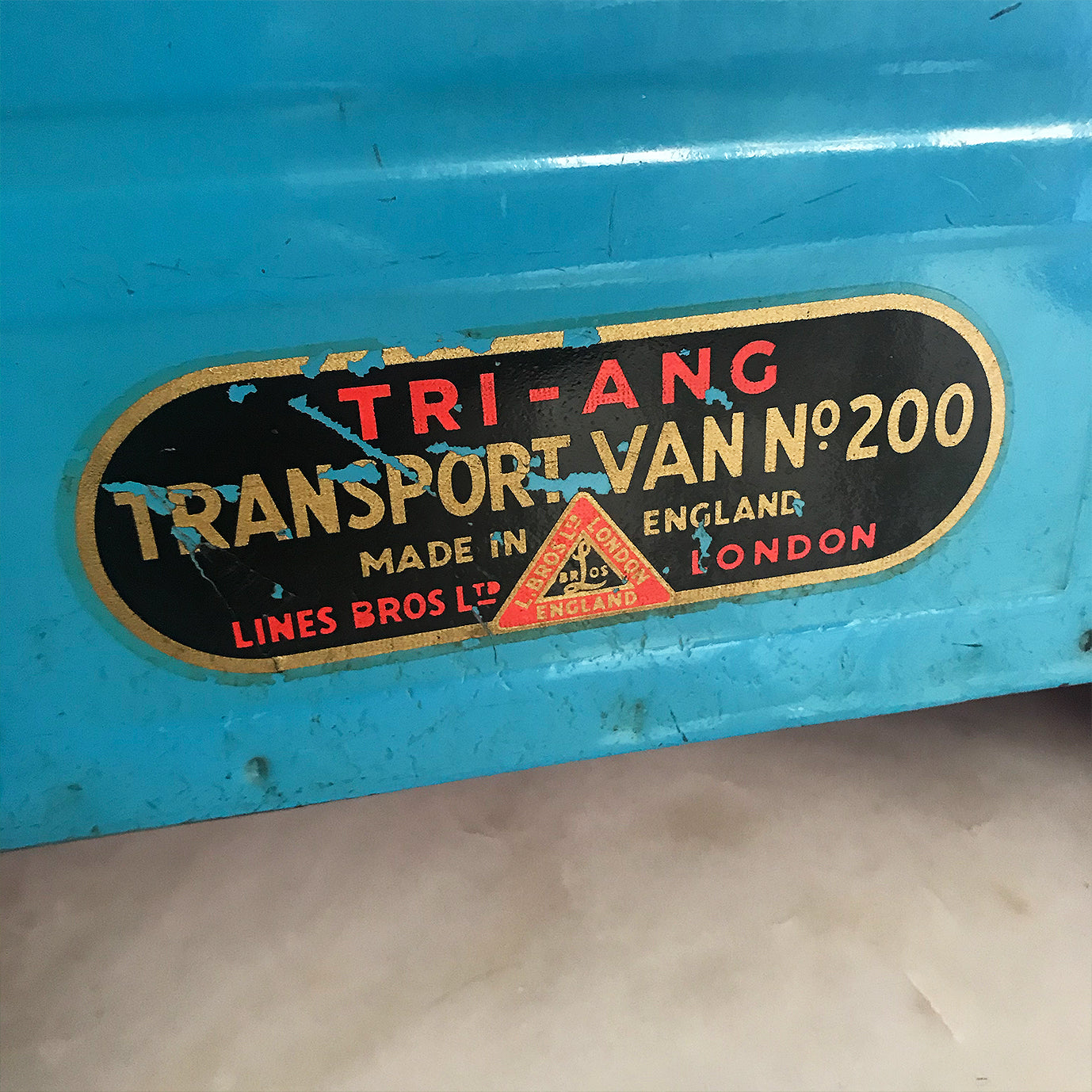 Cool Vintage Tri-ang Van No 200. The cab and wheel arches are finished in a popping red colour with the back storage section finished in a retro period light blue. It has two original Tri-ang decals on the sides and a pressed tin front radiator and lights - SHOP NOW - www.intovintage.co.uk