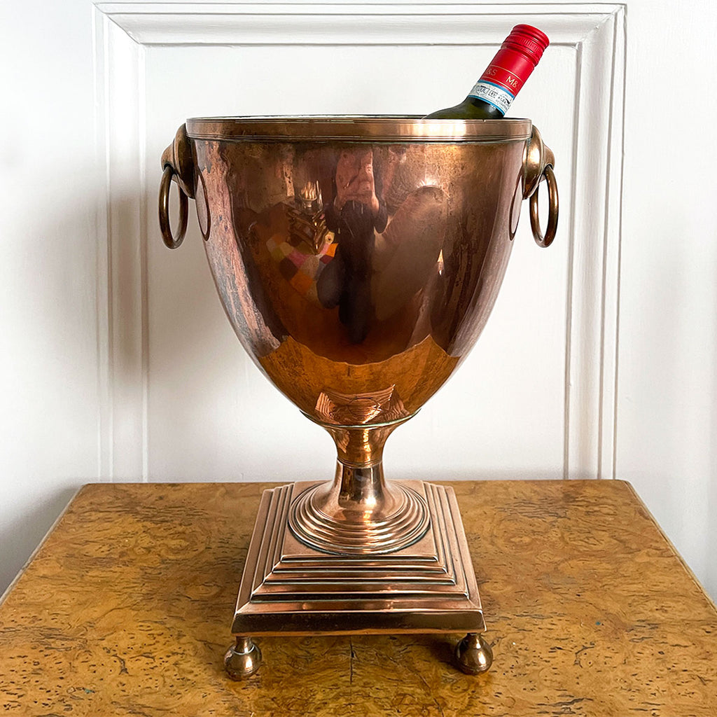 A Large Antique Classical Copper Urn ideal for use as a wine cooler. It has two ring handles and a beautiful stepped base stood on rounded feet -SHOP NOW - www.intovintage.co.uk
