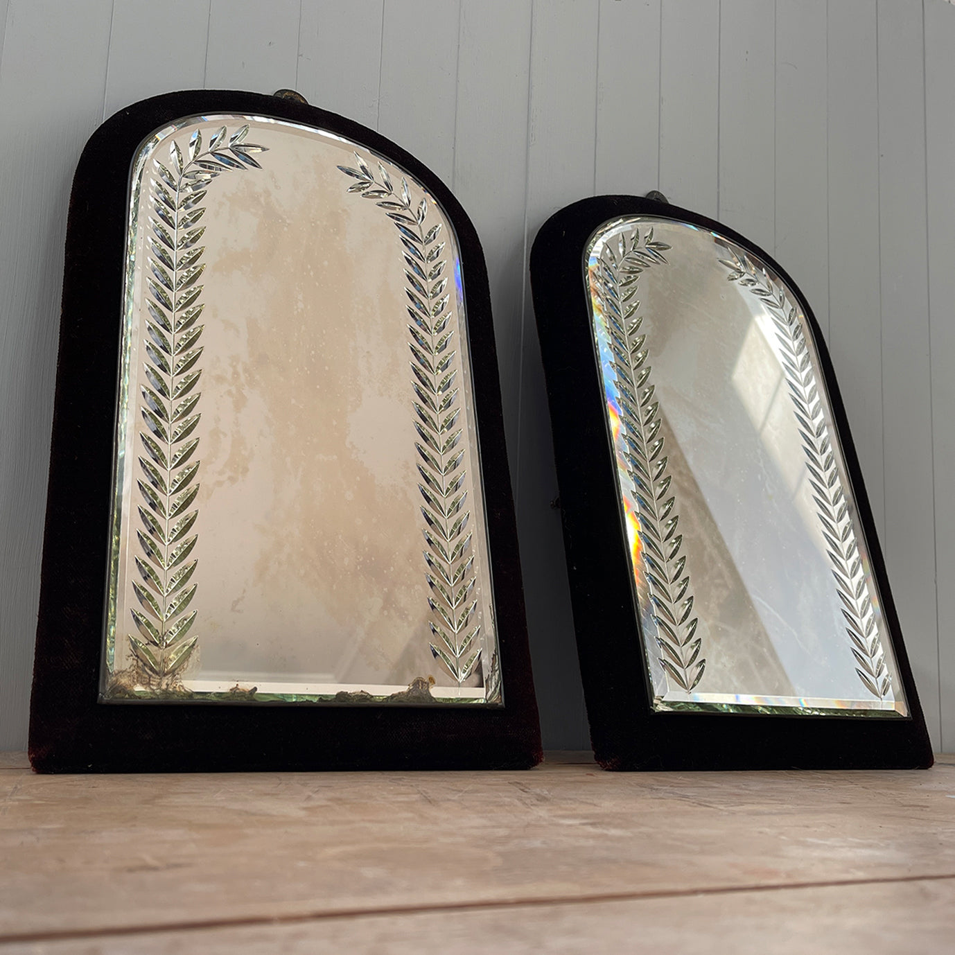 A fine pair of Victorian Velvet Framed Bright Cut Mirrors. Each mirror has deep red, almost black velvet frame with an arched mirror plate. The plates have bright cut leaf motifs that frame and catch the light beautifully - SHOP NOW - www.intovintage.co.uk