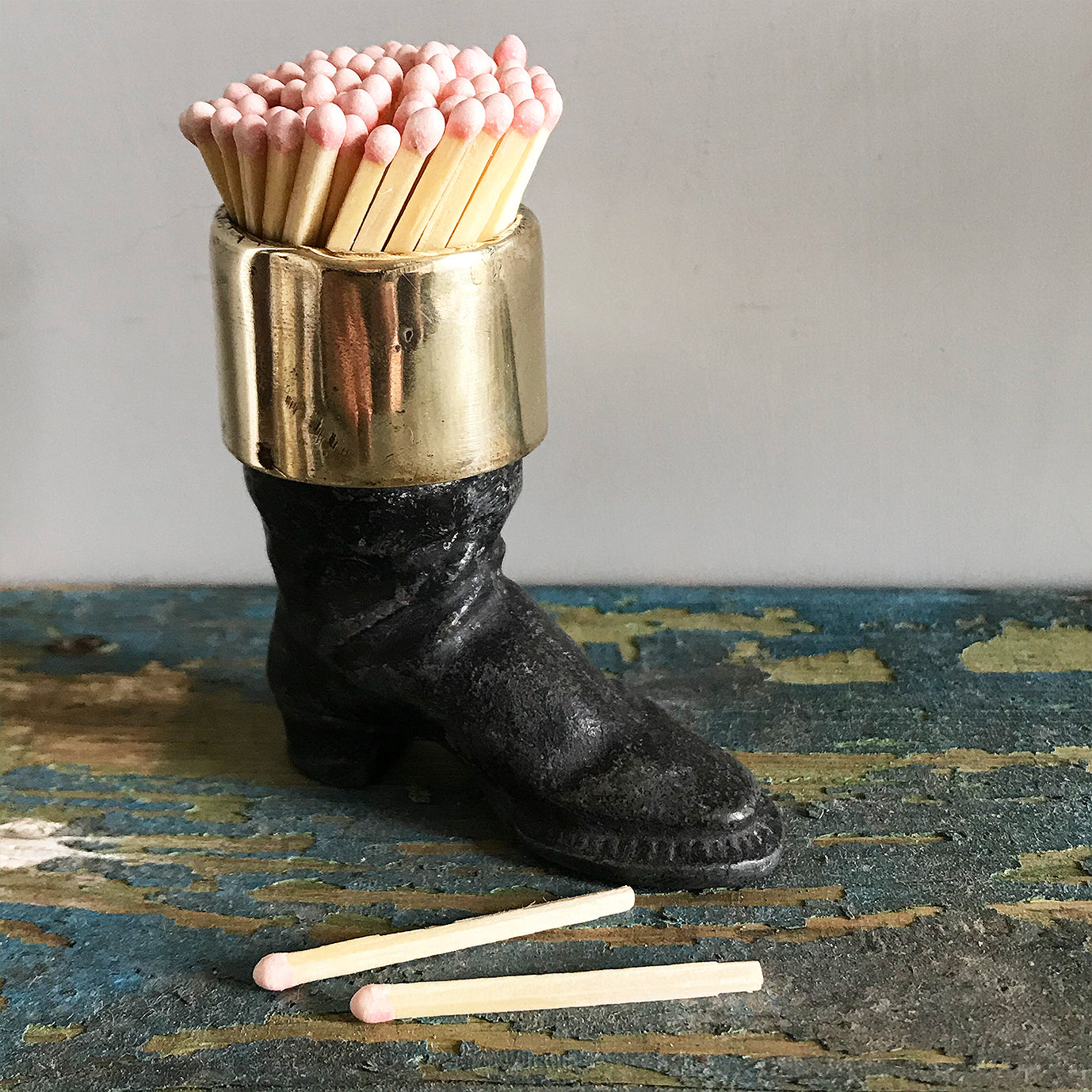 Well modelled Victorian vesta case of an old boot. Cast from metal with a brass cuff it has a striker on its sole to light your match - SHOP NOW - www.intovintage.co.uk