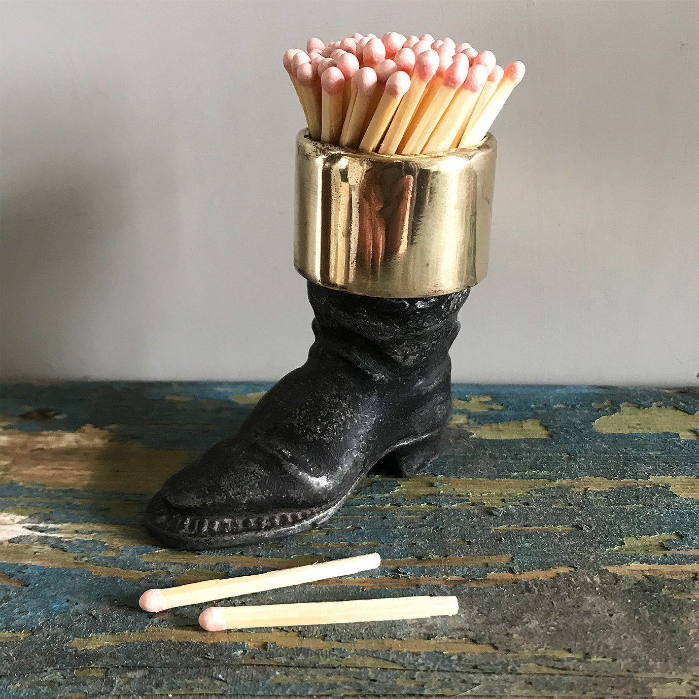 Well modelled Victorian vesta case of an old boot. Cast from metal with a brass cuff it has a striker on its sole to light your match - SHOP NOW - www.intovintage.co.uk